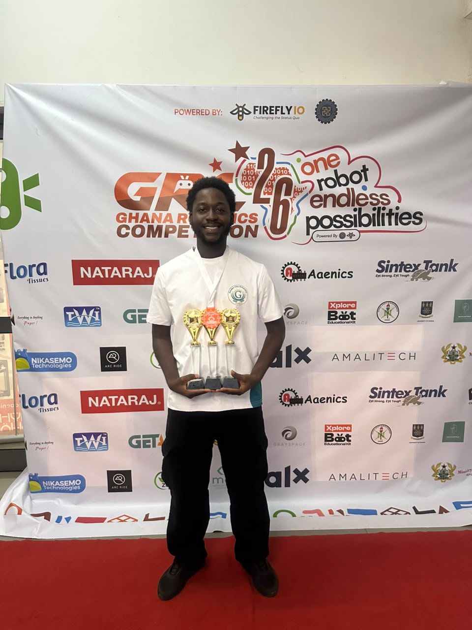 Team GCU member holding a trophy in front of the GRC 2026 backdrop